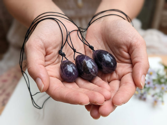 Woman holding in her hands Amethyst Yoni Eggs
