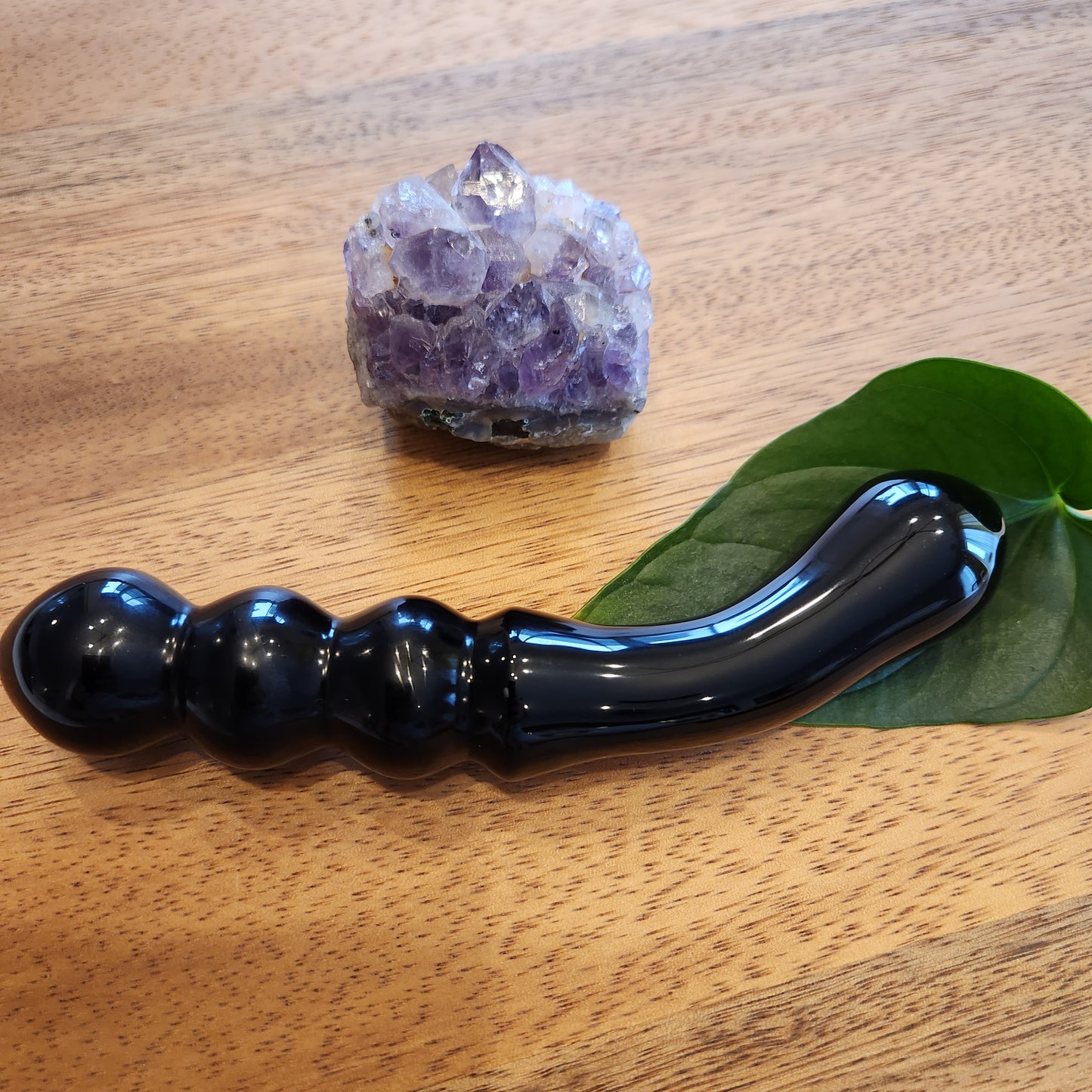 Unique black obsidian crystal wand with double-ended curved shape